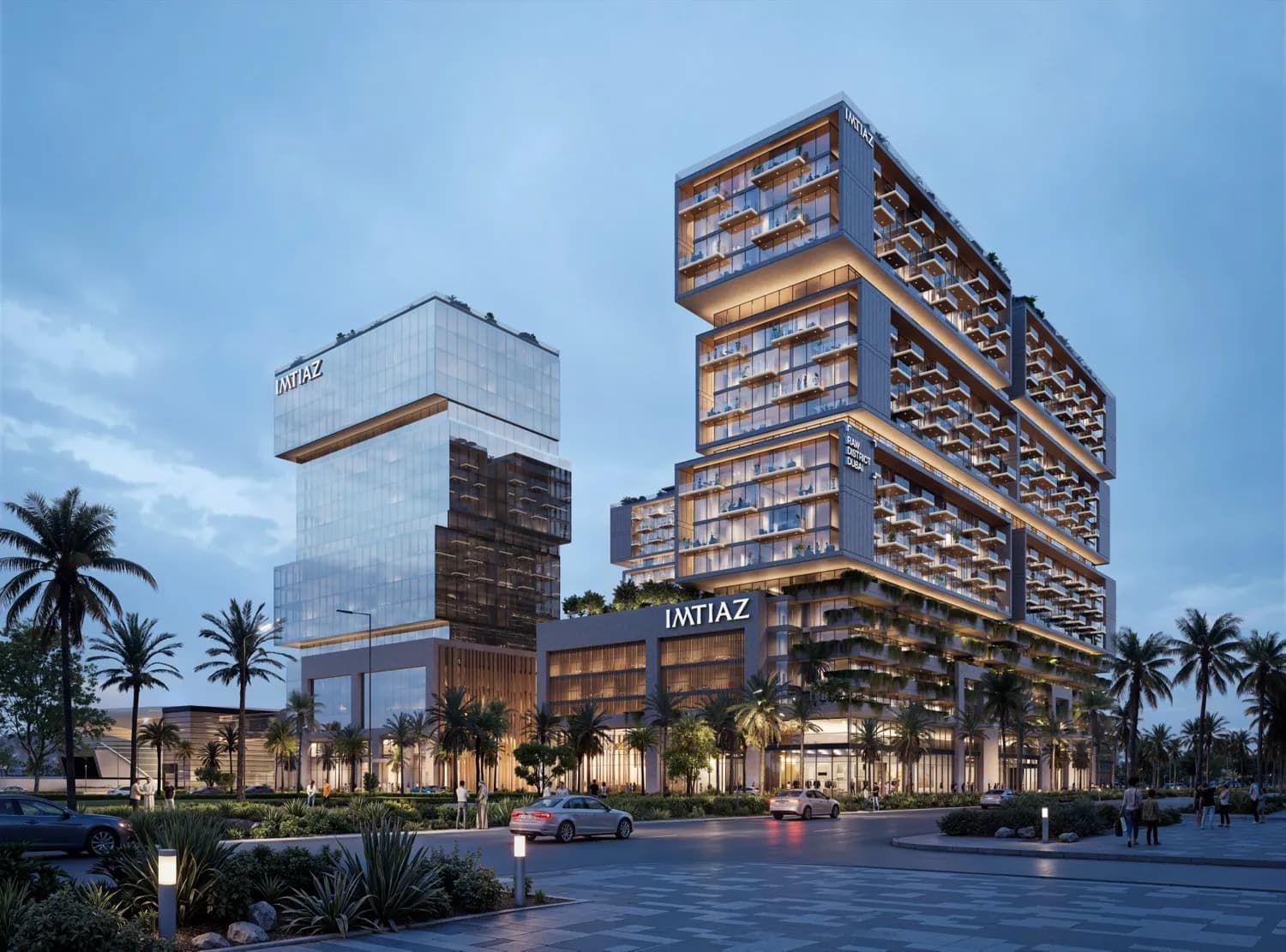 RAW District at dusk — lit balconies over the retail podium